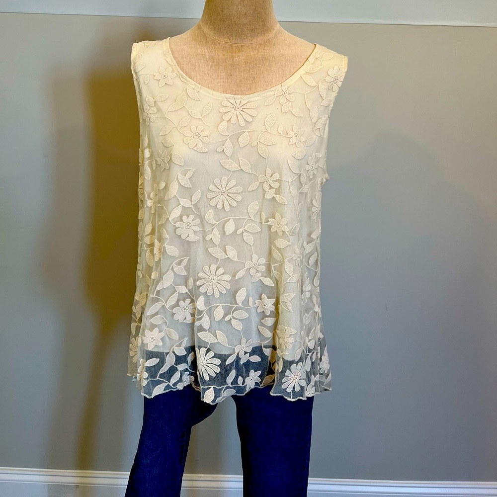 NWT!! This lace camisole with a floral design is a size large.